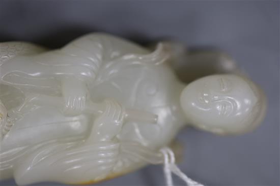 A fine Chinese white and russet jade group of Xi Wangmu and a phoenix, 19th/20th century, 9.5cm high, wood stand